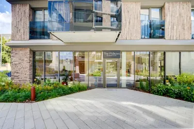 a building with glass doors in front of it at Pradoli apartament in Vilnius