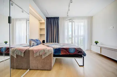 a bedroom with a bed with a glass wall at Pradoli apartament in Vilnius