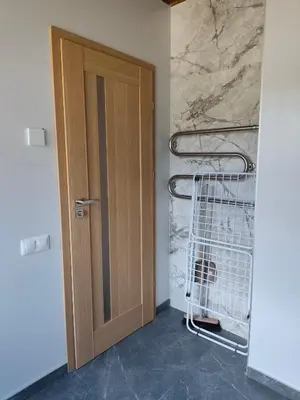 a door in a room with a shopping cart at CityPark Stay in Šiauliai