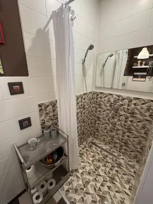 a bathroom with a shower with a shower curtain at Saga studio in the center of Pasvalys in Pasvalys
