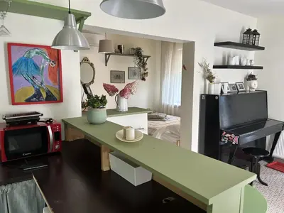 a living room with a desk and a television at Saga studio in the center of Pasvalys in Pasvalys