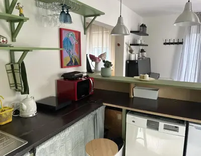 a kitchen with a counter with a red microwave at Saga studio in the center of Pasvalys in Pasvalys