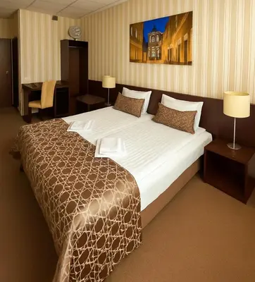 a bedroom with a large bed in a hotel room at Vilnius Hotel in Vilnius