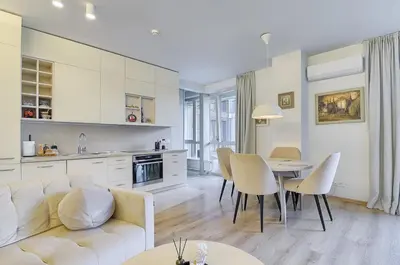a living room with a white couch and a table at Spacious 2 Bedroom Apartment in Central Vilnius in Vilnius
