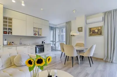 a living room with a couch and a table with chairs at Spacious 2 Bedroom Apartment in Central Vilnius in Vilnius