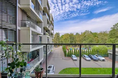 a balcony of a building with cars parked in a parking lot at Spacious 2 Bedroom Apartment in Central Vilnius in Vilnius