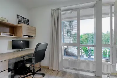 a home office with a desk and a chair and a window at Spacious 2 Bedroom Apartment in Central Vilnius in Vilnius