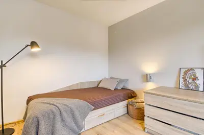 a small bedroom with a bed and a dresser at Spacious 2 Bedroom Apartment in Central Vilnius in Vilnius