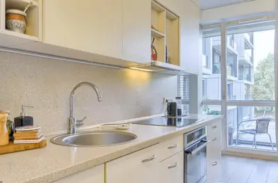 a kitchen with a sink and a large window at Spacious 2 Bedroom Apartment in Central Vilnius in Vilnius