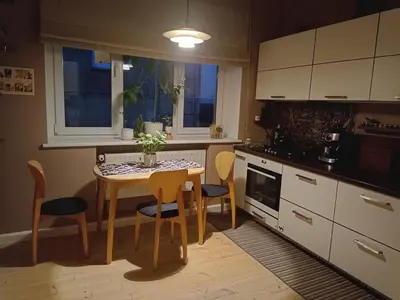 a kitchen with a small table and chairs in a kitchen at Kaunas Inn Colors in Kaunas