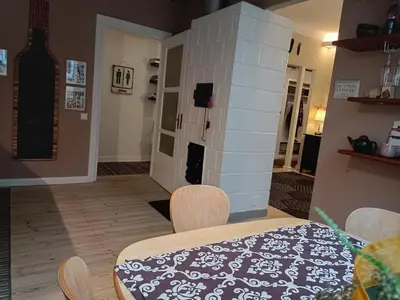 a dining room with a table and a brick wall at Kaunas Inn Colors in Kaunas