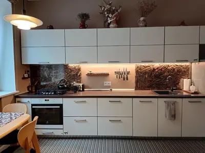 a kitchen with white cabinets and a sink at Kaunas Inn Colors in Kaunas