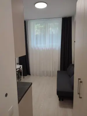 a living room with a couch and a window at CenterStudioFlat in Vilnius