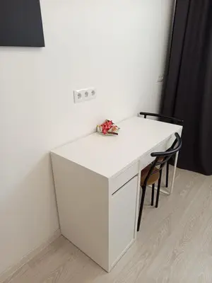 a white desk with two chairs in a room at CenterStudioFlat in Vilnius