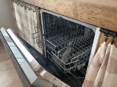 a dishwasher with a wire basket inside of it at LilHouse loftas Šiauliuose in Šiauliai