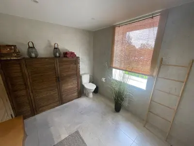 a bathroom with a toilet and a window and a ladder at LilHouse loftas Šiauliuose in Šiauliai