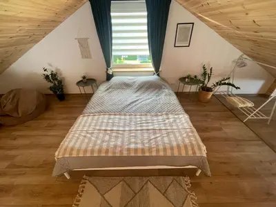 a bedroom with two beds in a attic at LilHouse loftas Šiauliuose in Šiauliai