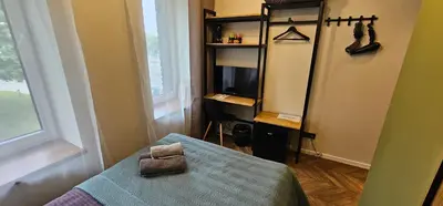 a bedroom with a bed and a tv in a room at Platforma2b one in Šiauliai