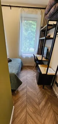 a room with a bed and a window and a book shelf at Platforma2b one in Šiauliai