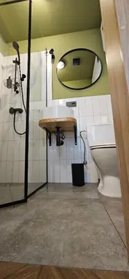 a bathroom with a sink and a toilet and a mirror at Platforma2b one in Šiauliai