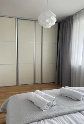 a bedroom with a bed with two towels on it at Šiaulių centre modernus butas 1-4 žmonėms in Šiauliai