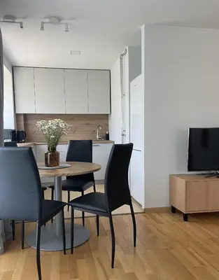 a kitchen and dining room with a table and chairs at Šiaulių centre modernus butas 1-4 žmonėms in Šiauliai