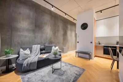 a living room with a couch and a table at NG Charm in Old Town Apt w-Terrace & Netflix in Vilnius