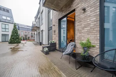 a patio with a christmas tree in a building at NG Charm in Old Town Apt w-Terrace & Netflix in Vilnius
