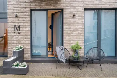 two chairs and a table in front of a building at NG Charm in Old Town Apt w-Terrace & Netflix in Vilnius