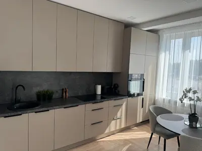 a kitchen with white cabinets and a table and a window at City Centre Apartment with Cathedral View, Self Check-in in Šiauliai
