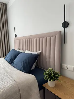 a bedroom with a bed with blue pillows and a table at City Centre Apartment with Cathedral View, Self Check-in in Šiauliai