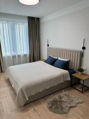 a bedroom with a large bed with blue pillows at City Centre Apartment with Cathedral View, Self Check-in in Šiauliai