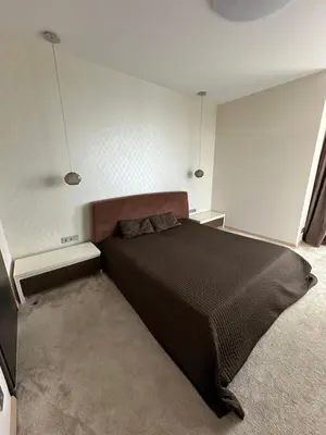 a bedroom with a large black bed in a room at Vilnius SkyView 19 in Vilnius