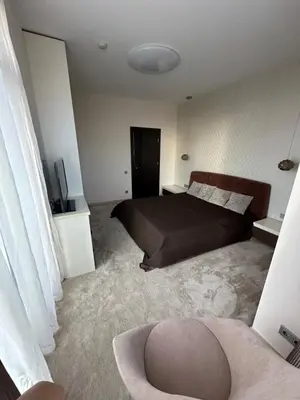 a bedroom with a bed and a couch in a room at Vilnius SkyView 19 in Vilnius