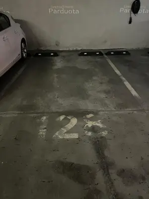 a white car parked in a parking lot at Vilnius SkyView 19 in Vilnius