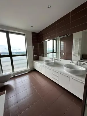 a large bathroom with two sinks and two mirrors at Vilnius SkyView 19 in Vilnius