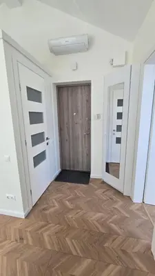 a room with a door and a wooden floor at Santakos apartmentai in Kaunas