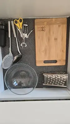 a shelf with various kitchen utensils on it at Santakos apartmentai in Kaunas
