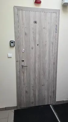 a wooden door with the number on it at Santakos apartmentai in Kaunas