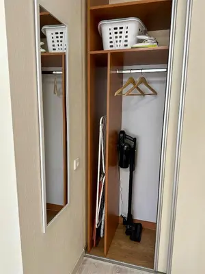 a mirror in a room with a closet at Cozy Šmozy Apartamentai in Šiauliai