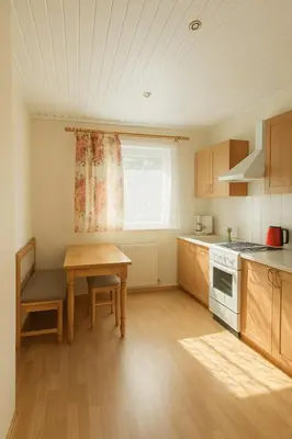 a kitchen with a table and a table and a window at Home in Santariskes in Vilnius