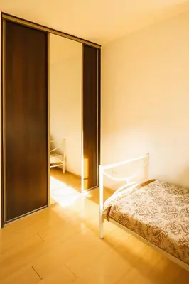 a bedroom with a bed and a sliding glass door at Home in Santariskes in Vilnius