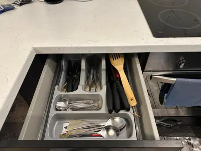 a drawer in a counter with utensils in it at Modern apartment with balcony in Užliedžiai
