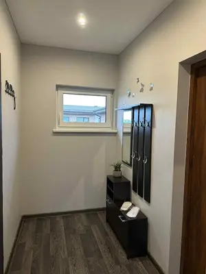a bathroom with a sink and a mirror and a window at Modern apartment with balcony in Užliedžiai