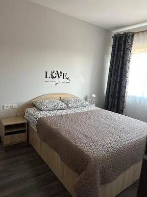 a bedroom with a bed and a window at Modern apartment with balcony in Užliedžiai
