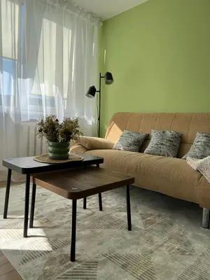 a living room with a couch and a coffee table at DvaroStudio jaukus butas centre self-check-in in Šiauliai