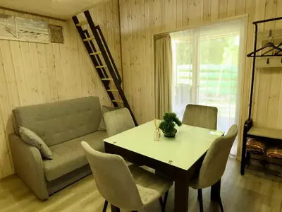 a living room with a table and a couch at Gray House in Marijampolė