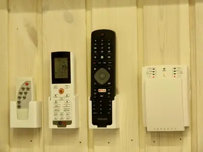 a remote control and other electronic devices on a wall at Gray House in Marijampolė