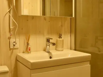 a bathroom with a white sink and a mirror at Gray House in Marijampolė