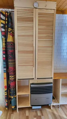 a wooden cabinet with two windows in a room at Houseboat Vilnius in Vilnius